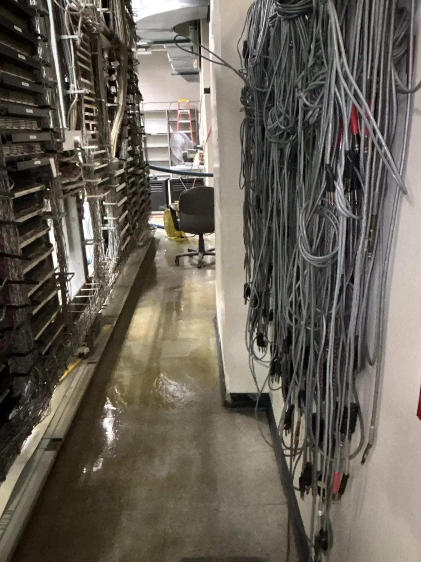 Bundled cables in a wet data room with water on the floor